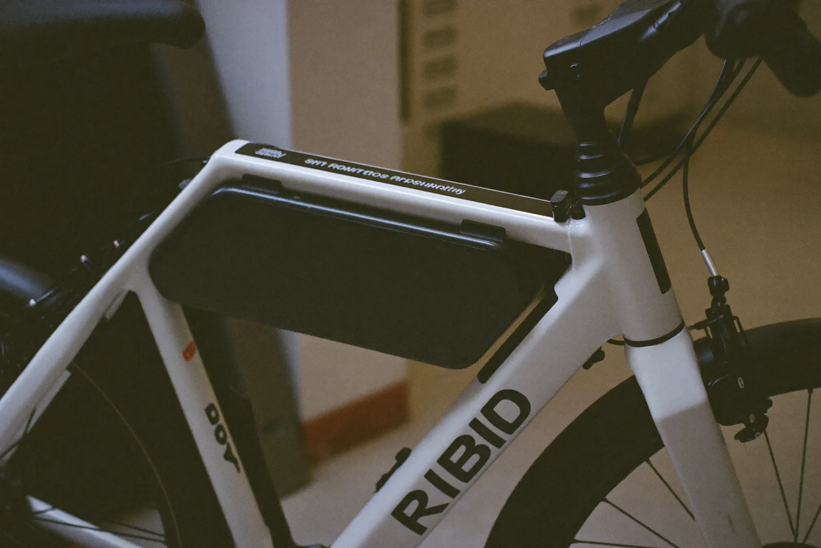 Close-up of an e-bike frame with its integrated battery and small display